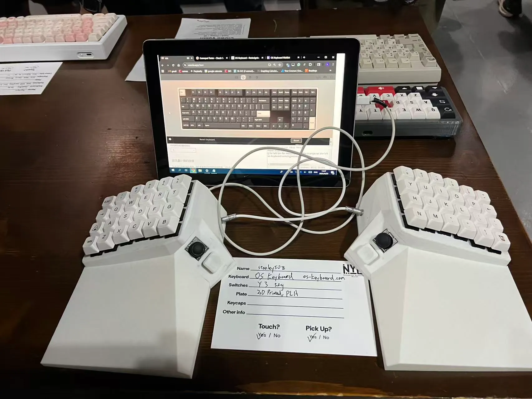 Finished keyboard at an in-person meetup table with a sign-up sheet
