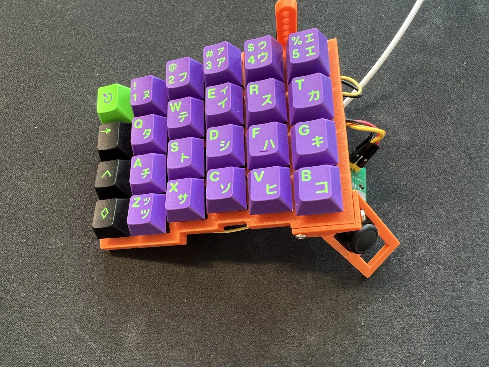 Early single-half prototype with purple keycaps in an orange 3D-printed case