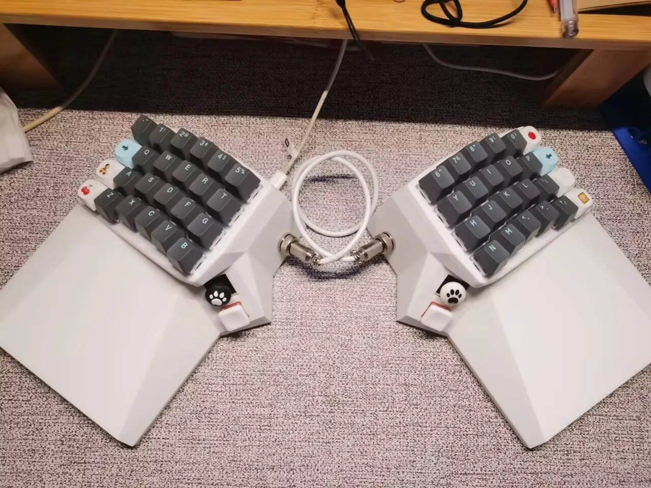 White OS Keyboard with grey keycaps on a carpet