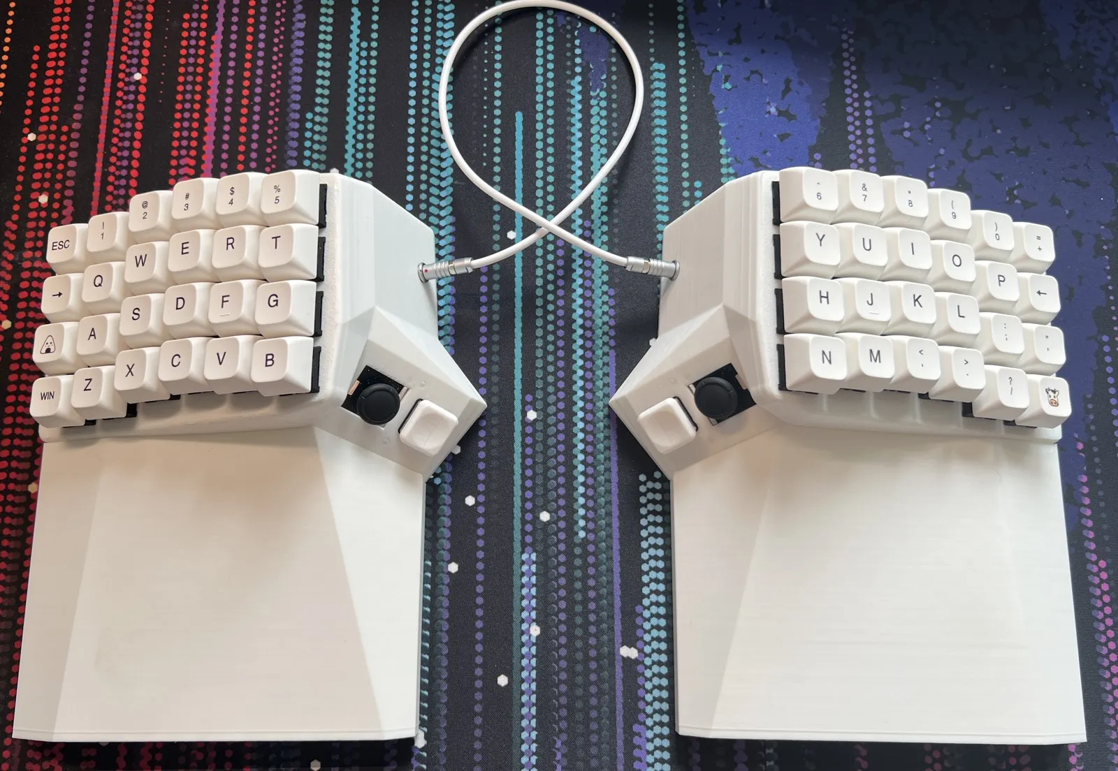 White O2 prototype on a patterned desk mat